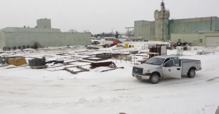 Field truck at a snow-covered former industrial property during a site assessment